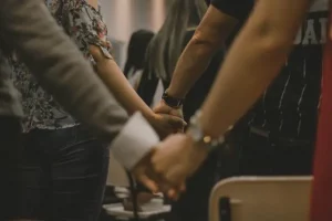 church congregation members holding hands